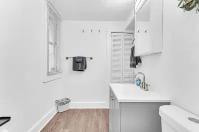 a white kitchen with a sink and a window at Historic Cozy Haven in Little Italy in Cleveland