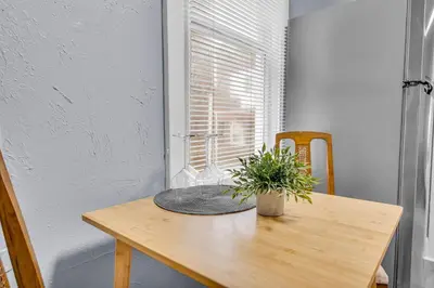 a wooden table with a potted plant on it at Historic Cozy Haven in Little Italy in Cleveland