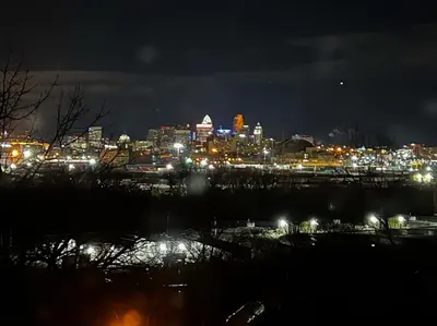 a view of a city at night with lights at Skyline Retreat Spacious Elegance Queen Suite 1 City Views in Cincinnati