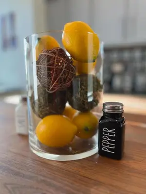 a glass jar filled with fruit and a jar of chocolates at Skyline Retreat Spacious Elegance Queen Suite 3 City Views in Cincinnati