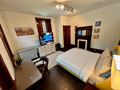 a bedroom with a bed and a television in it at Skyline Retreat Spacious Elegance Queen Suite 3 City Views in Cincinnati