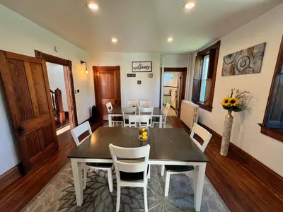 a dining room with a wooden table and chairs at Skyline Retreat Spacious Elegance Queen Suite 3 City Views in Cincinnati