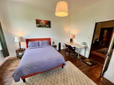 a bedroom with a bed and a desk at Skyline Retreat Spacious Elegance Queen Suite 4 City Views in Cincinnati