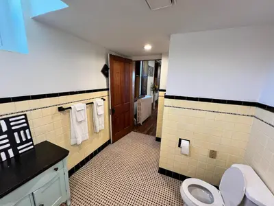 a bathroom with a toilet and a sink at Skyline Retreat Spacious Elegance Queen Suite 4 City Views in Cincinnati