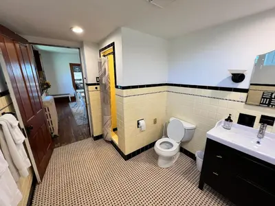 a bathroom with a toilet and a sink at Skyline Retreat Spacious Elegance Queen Suite 4 City Views in Cincinnati