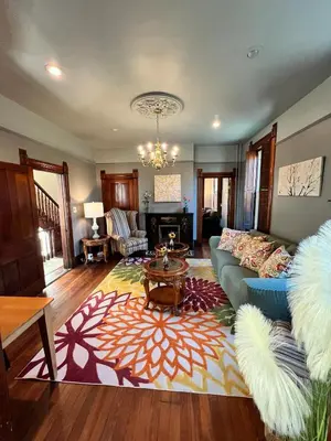 a living room with a couch and a table at Skyline Retreat Spacious Elegance Queen Suite 4 City Views in Cincinnati
