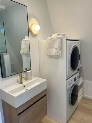 a bathroom with a sink and a mirror and a tv at Fox Ridge-Black Alder Lodging in Logan