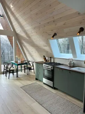 a kitchen with a stove and a table with chairs at Fox Ridge-Black Alder Lodging in Logan