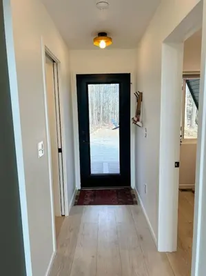 a hallway with a black door with a window at Fox Ridge-Black Alder Lodging in Logan