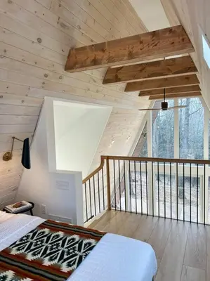 a bedroom with a bed in a room with a balcony at Fox Ridge-Black Alder Lodging in Logan