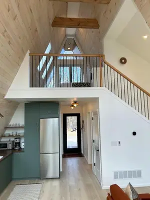 a kitchen with a staircase and a refrigerator in a house at Fox Ridge-Black Alder Lodging in Logan