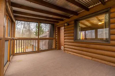 a room with a large window on the front of a house at WinklerWald- 6 BR family retreat in Atwater