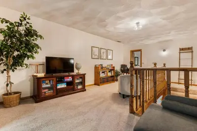 a living room with a flat screen tv and a couch at WinklerWald- 6 BR family retreat in Atwater