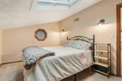 a bedroom with a bed and a skylight at WinklerWald- 6 BR family retreat in Atwater
