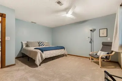 a bedroom with a bed and a chair in it at WinklerWald- 6 BR family retreat in Atwater