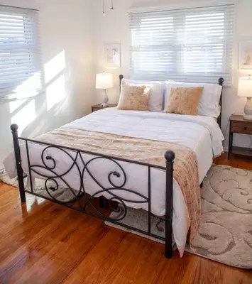 a bedroom with a large bed with white sheets and pillows at Cozy 3 Bedroom Home in Reynoldsburg