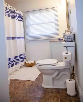 a bathroom with a toilet and a shower at Cozy 3 Bedroom Home in Reynoldsburg