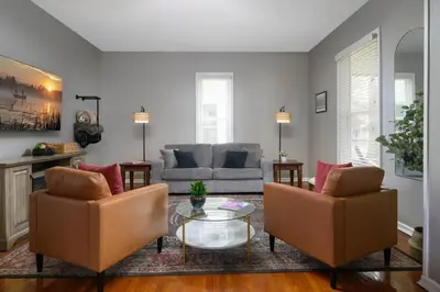 a living room with two chairs and a couch at Elegant House 2 min from BSU/Hospital/Downtown in Muncie