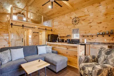a living room with a couch and a table in a cabin at Friends and Family Rental Cabin with Hot Tub! in Somerset