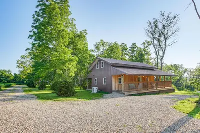 a home with a barn and a gravel driveway at Friends and Family Rental Cabin with Hot Tub! in Somerset