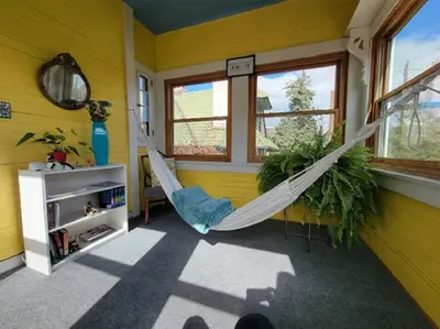 a room with a hammock in a room with yellow walls at The Kings Throne Inn and Guest House in Toledo