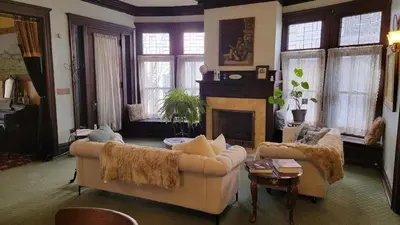 a living room with a couch and a fireplace at The Kings Throne Inn and Guest House in Toledo