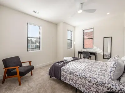a bedroom with a bed and a chair and a desk at Modern Luxury 4BR 3 5BA Oasis in Historic Old Town East PD in Columbus