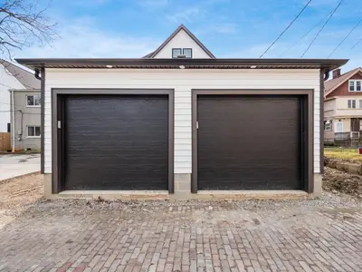 two large garage doors in front of a house at Modern Luxury 4BR 3 5BA Oasis in Historic Old Town East PD in Columbus