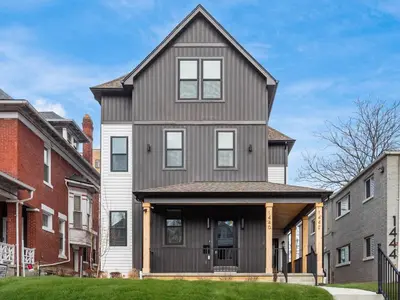 a gray house with a gambrel roof at Modern Luxury 4BR 3 5BA Oasis in Historic Old Town East PD in Columbus