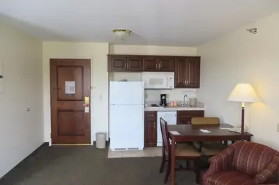 a kitchen with a table and a white refrigerator at Hawthorn Extended Stay by Wyndham Seville in Seville