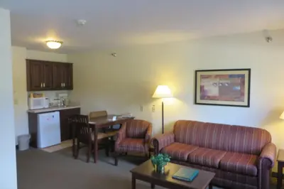 a living room with a couch and a table at Hawthorn Extended Stay by Wyndham Seville in Seville