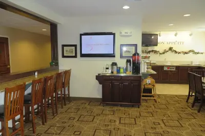 a bar in a waiting room with a screen on the wall at Hawthorn Extended Stay by Wyndham Seville in Seville