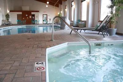 a swimming pool with a hot tub in a building at Schoenbrunn Inn in New Philadelphia