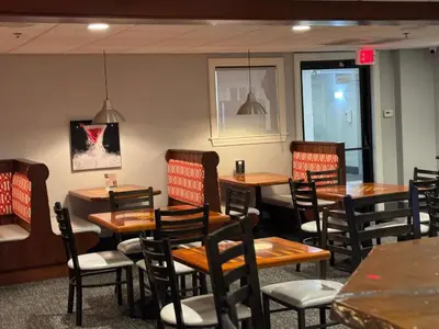 a dining room with wooden tables and chairs at Schoenbrunn Inn in New Philadelphia