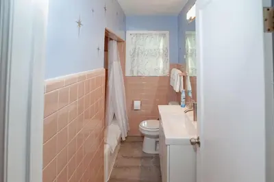 a bathroom with a toilet and a sink at Refreshing Mid Mod Retreat BG in Bowling Green