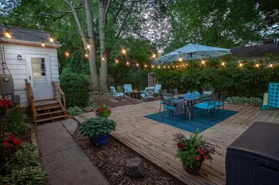 a patio with a table and chairs and lights at Refreshing Mid Mod Retreat BG in Bowling Green