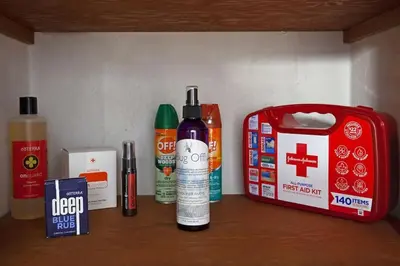 a shelf with bottles ofodorizers and a red box at Refreshing Mid Mod Retreat BG in Bowling Green