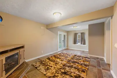 an empty living room with a rug on the floor at Come indulge and escape away! in Salem