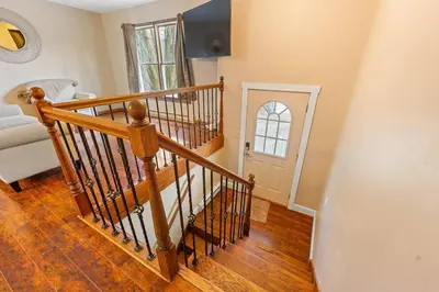a spiral staircase in a living room with a stair case at Come indulge and escape away! in Salem