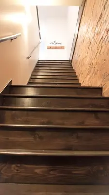 a staircase in a building with a sign on the wall at Private Boutique Getaway - Fireplace & Soaking Tub - Downtown Loft - by Cross-Key Vacation Rentals in Millersburg