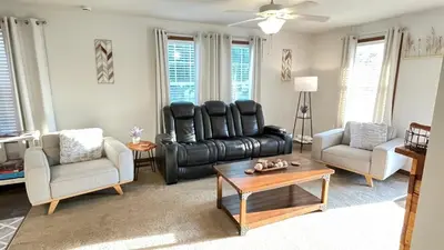 a living room with a black leather couch and chairs at 3 Bedroom in Hocking Hills w King Bed Logan Ohio in Logan