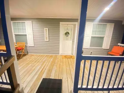 a view of a room with a porch with a wooden floor at 3 Bedroom in Hocking Hills w King Bed Logan Ohio in Logan