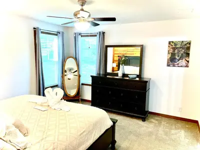 a bedroom with a bed and a mirror and a dresser at 3 Bedroom in Hocking Hills w King Bed Logan Ohio in Logan