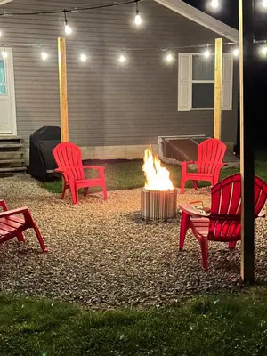 two red chairs and a fire pit in a yard at 3 Bedroom in Hocking Hills w King Bed Logan Ohio in Logan
