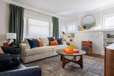 a living room with a couch and a table at Modern 3BR Near Cleveland Clinic in Cleveland Heights