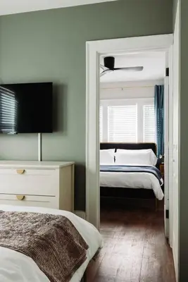 a bedroom with two beds and a mirror at Modern 3BR Near Cleveland Clinic in Cleveland Heights