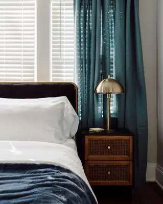 a bedroom with a bed and a lamp on a night stand at Modern 3BR Near Cleveland Clinic in Cleveland Heights
