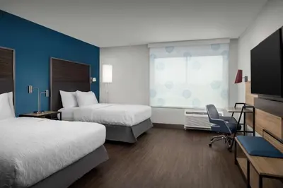 a hotel room with two beds and a television at Tru By Hilton Columbus East Broad in Columbus