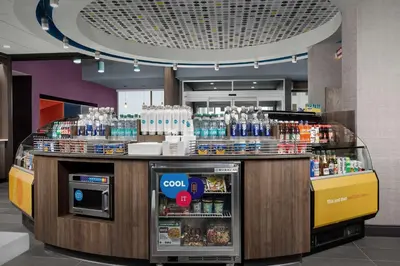 a counter in a store with a lot of drinks at Tru By Hilton Columbus East Broad in Columbus