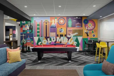 a pool table in a room with a mural at Tru By Hilton Columbus East Broad in Columbus